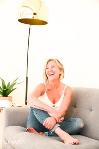 An executive, dressed in casual attire, sits comfortably with a relaxed posture. She's with a friendly smile on her face. This image can be used for bio, business cards and social media posts.